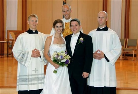 A July 23, 2011, photo provided by Bernadette Strand shows Father Luke Strand, center, after marrying sister Theresa and Christopher Krausert in Dousman, Wis. Also shown is Jacob Strand, left, and Vincent Strand, right. All three brothers have decided to become priests.
